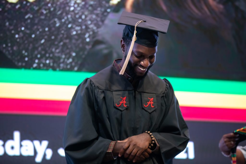 Student smiling as walking across the stage