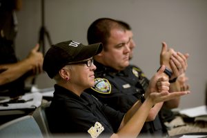 Close-up side view of police officers practicing sign language